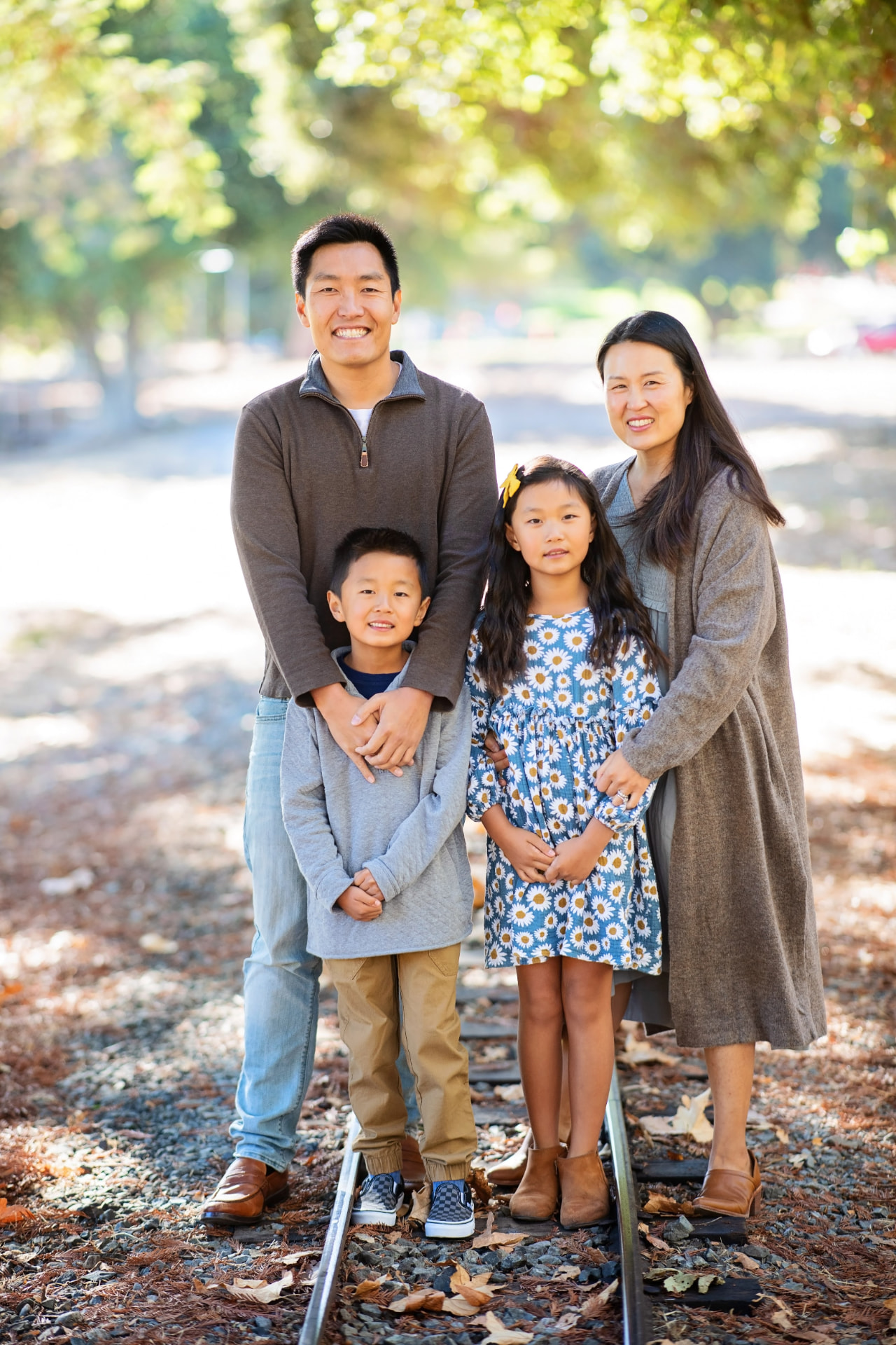 Charles Hsieh with his wife and two children outdoors